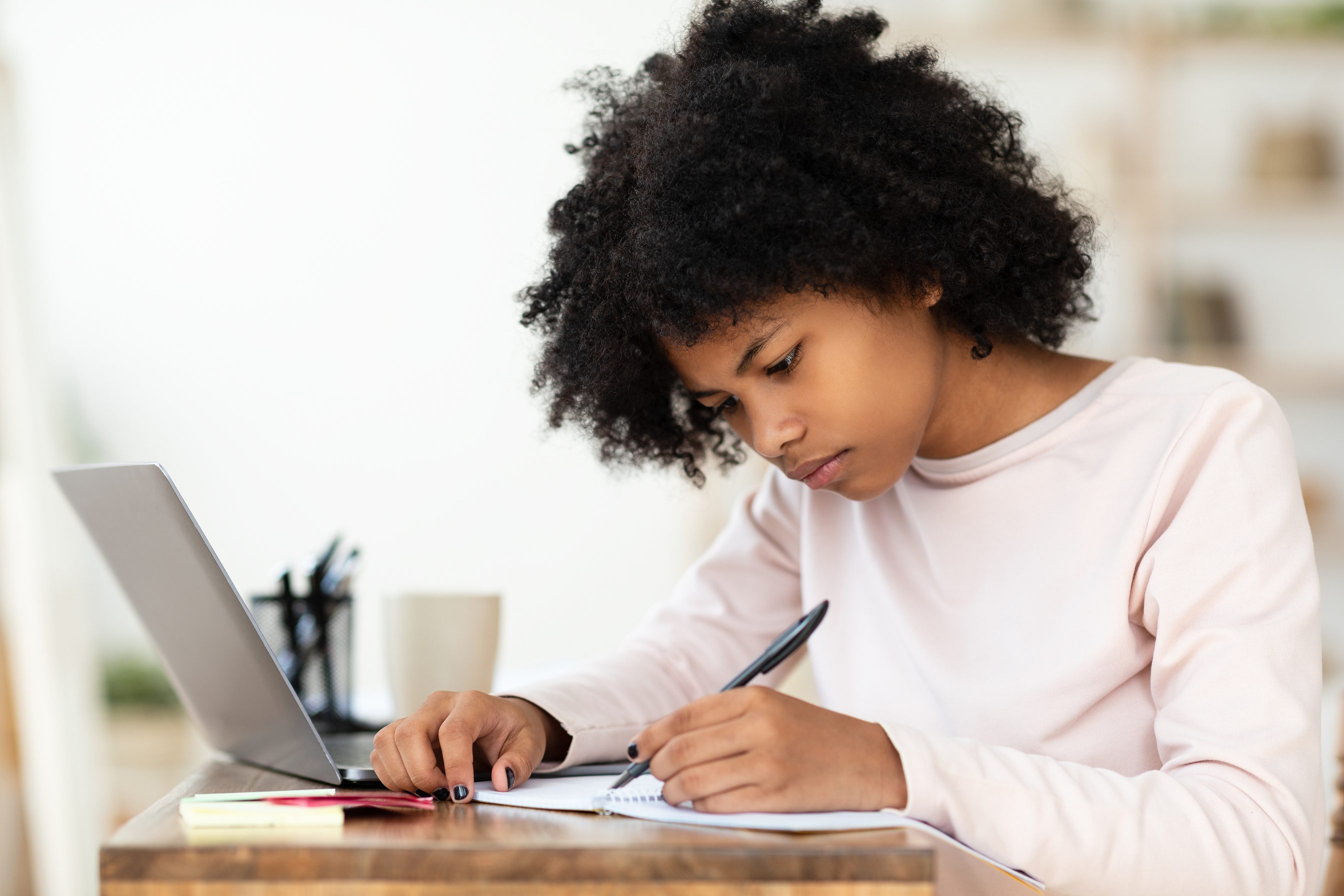 Black Schoolgirl Writing Essay Doing Homework Sitting At Home